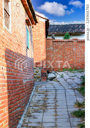 Alleyway in Houlong Port, Miaoli County, Taiwan with Brick Walls. Alleyway in Houlong Port, Miaoli County, Taiwan with Brick Walls. 126908760