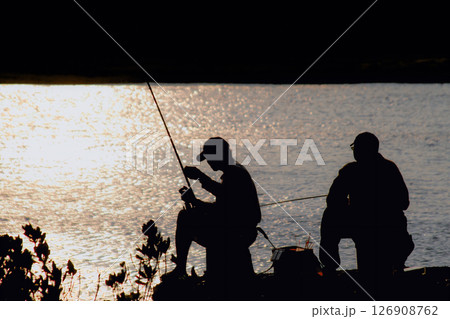 Silhouettes of Fishermen at Sunset in Houlong Port, Miaoli, Taiwan. Silhouettes of Fishermen at Sunset in Houlong Port, Miaoli, Taiwan. 126908762