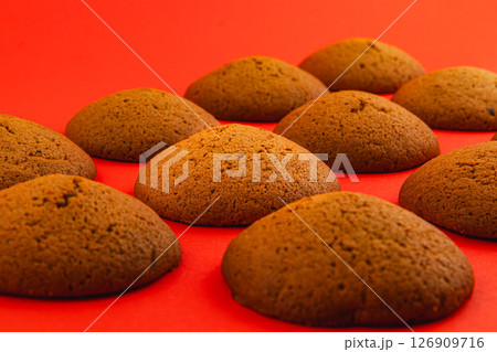 Freshly baked cookies arranged on a vibrant red surface Freshly baked cookies arranged on a vibrant red surface 126909716