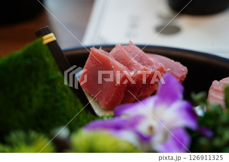 Close-up of Sliced Tuna Sashimi on Black Plate 126911325