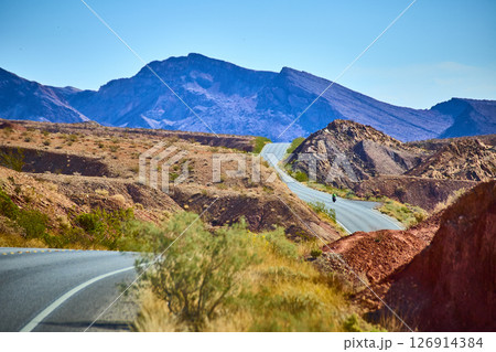Desert Road Adventure with Motorcyclist Eye-Level Perspective Desert Road Adventure with Motorcyclist Eye-Level Perspective 126914384