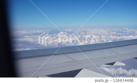 Airplane wing flying over the himalayas mountain range 126914486