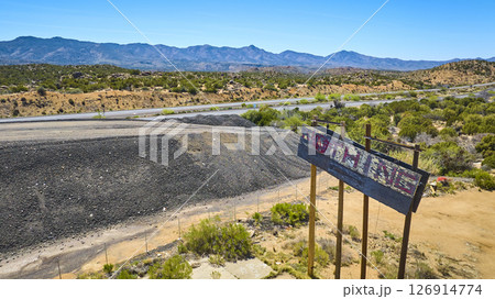 Aerial Weathered Roadside Sign Abandoned Highway Desert Landscape Fly Through 126914774