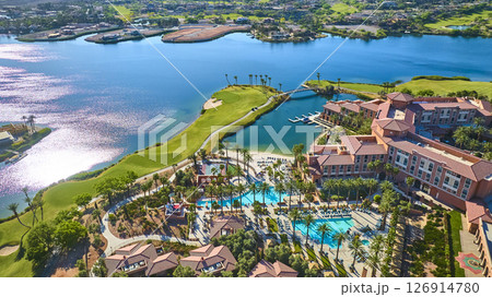 Aerial Luxury Lakeside Resort with Pools and Golf Course Fly Over 126914780