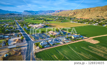 Aerial Farmland Suburban Homes and Church at Sunrise in Hurricane Utah Fly Over 126914835