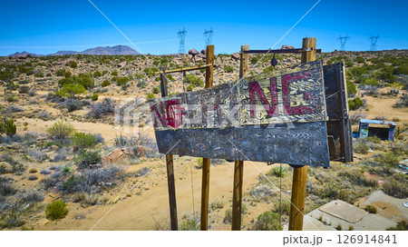 Aerial Abandoned Wooden NOTHING Sign Desert Landscape Power Lines Elevated View 126914841