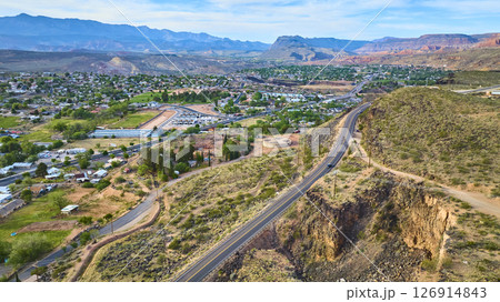 Aerial Highway Winding Through Desert Town and Mountain Range Fly Over Aerial Highway Winding Through Desert Town and Mountain Range Fly Over 126914843