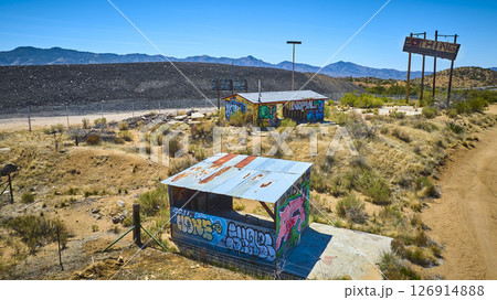 Aerial of Abandoned Graffiti Desert Buildings and NOTHING Signpost Arizona 126914888
