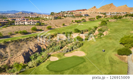 Aerial Luxury Golf Course Green with Sand Bunkers and Desert Homes Fly Over 126915009