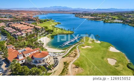 Aerial Luxury Lakeside Resort Golf Course and Marina with Palm Trees Fly Over 126915052