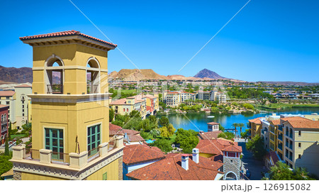 Aerial Mediterranean Village Tower and Lake Oasis in Desert Setting 126915082