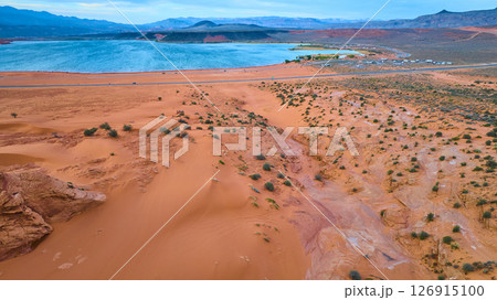 Aerial Sand Dunes and Blue Reservoir with Desert Mountains Fly Over Aerial Sand Dunes and Blue Reservoir with Desert Mountains Fly Over 126915100