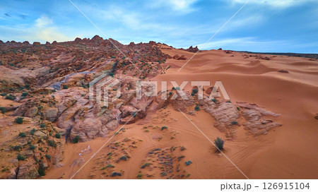 Aerial Red Rock Ridges and Sand Dunes in Motion Over Desert Landscape Aerial Red Rock Ridges and Sand Dunes in Motion Over Desert Landscape 126915104