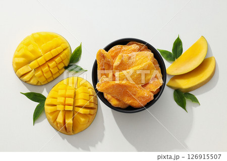 A bowl of dried mango chips with fresh sliced mango A bowl of dried mango chips with fresh sliced mango 126915507