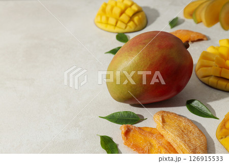 Fresh and dried mangoes on a white background Fresh and dried mangoes on a white background 126915533