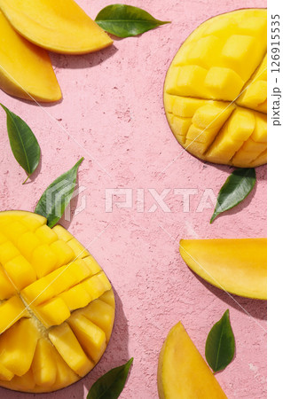 Fresh cut mango on a pink background 126915535