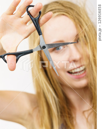 Woman with scissors ready to hair cutting Woman with scissors ready to hair cutting 126916858
