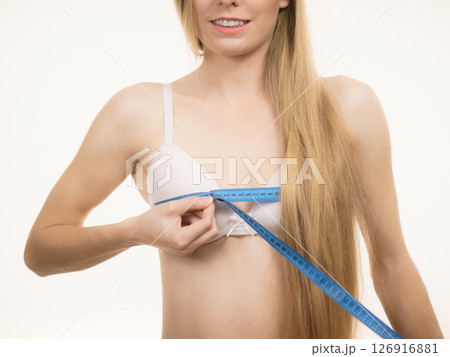 Woman measuring her chest breasts bust size 126916881