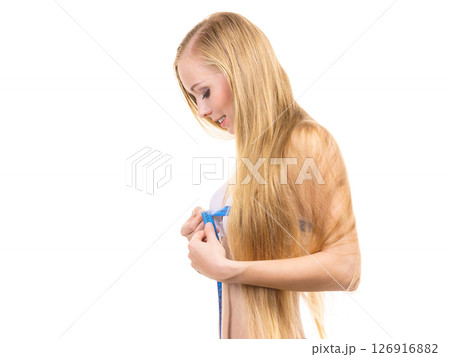 Woman measuring her chest breasts bust size Woman measuring her chest breasts bust size 126916882