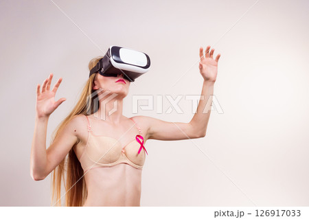 Girl in bra pink cancer ribbon and vr box 126917033
