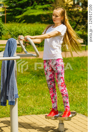 Female doing exercise in outdoor gym Female doing exercise in outdoor gym 126917100