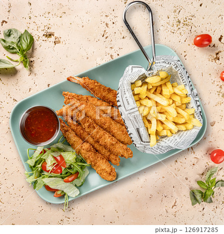 Breaded shrimps served with french fries 126917285