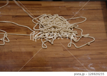 The chef makes noodles by hand. Handmade noodles for lagman. The chef makes noodles by hand. Handmade noodles for lagman. 126920235