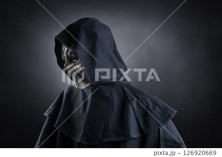 Portrait of a creepy monster with hooded cloak over dark misty background Portrait of a creepy monster with hooded cloak over dark misty background 126920669