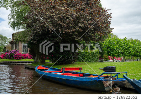 Landscape view of famous Giethoorn village in Netherlands with canals and boat Landscape view of famous Giethoorn village in Netherlands with canals and boat 126922652