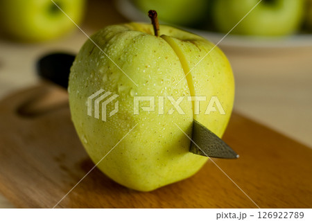 A beautiful green apple with a knife A beautiful green apple with a knife 126922789