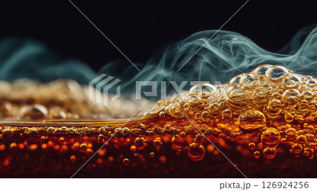 Macro shot of black tea surface with steam curling upward, detailed bubbles and reflections 126924256