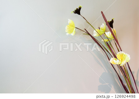 fake flowers yellow  on cream background 126924498