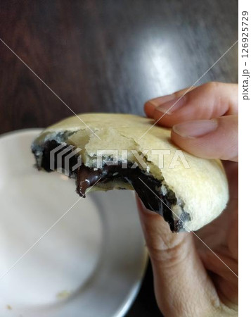 BIte of Traditional Izmir Bomba Pastries on a White Plate, Close Up BIte of Traditional Izmir Bomba Pastries on a White Plate, Close Up 126925729