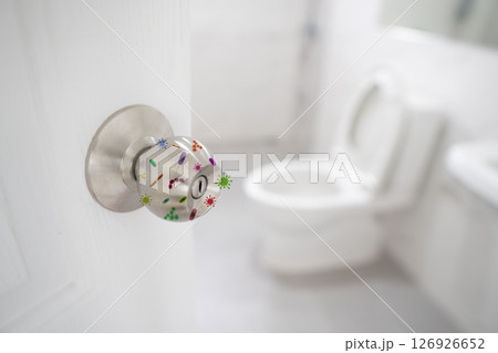 Close up of the door knob bathroom with germ bacteria and virus spreading with illness in public. Infectious diseases spread hygiene concept. 126926652