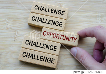 Challenges and Opportunities Coexist, a reminder that every challenge carries potential opportunities, shown through opposing wooden block messages 126926809