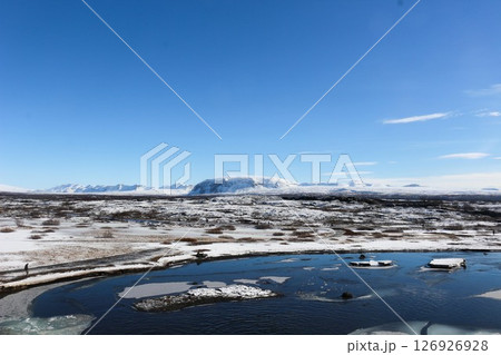 Thingvellir National Park on a blue sky day with the lake covered with ice and snow taken in March 126926928