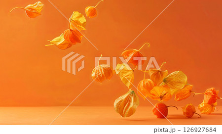 Elegant fall leaves float gracefully in an artistic dance of orange and gold, captured in soft ethereal ligh 126927684