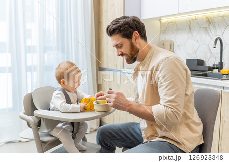 Single father having breakfast with his little baby boy Single father having breakfast with his little baby boy 126928848