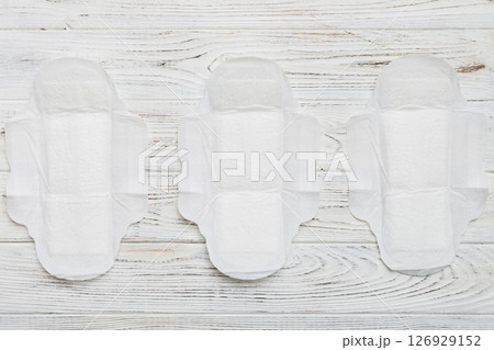 Women hygiene products or sanitary pad on colored background. Pastel color. Closeup. Empty place for text. Female daily hygiene Women hygiene products or sanitary pad on colored background. Pastel color. Closeup. Empty place for text. Female daily hygiene 126929152