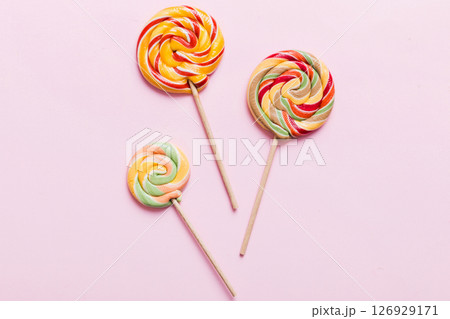Set of colorful lollipops on colored background. Summer concept. Party Happy Birthday or Minimalist Concept Set of colorful lollipops on colored background. Summer concept. Party Happy Birthday or Minimalist Concept 126929171