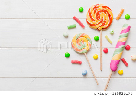Tasty appetizing Party Accessories Happy Birthday Sweet. Different types of candies on colored background, copy space. Colorful birthday party background Tasty appetizing Party Accessories Happy Birthday Sweet. Different types of candies on colored background, copy space. Colorful birthday party background 126929179