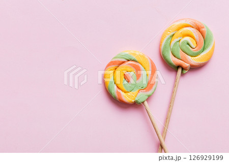 Set of colorful lollipops on colored background. Summer concept. Party Happy Birthday or Minimalist Concept Set of colorful lollipops on colored background. Summer concept. Party Happy Birthday or Minimalist Concept 126929199