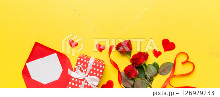 Valentine day composition with Envelope, rose flower and Red heart on table. Top view, flat lay. Holiday concept 126929233