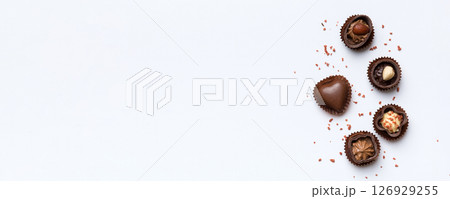 Different kinds of chocolates on colored table close-up. Top View and Flat Lay with copy space Different kinds of chocolates on colored table close-up. Top View and Flat Lay with copy space 126929255