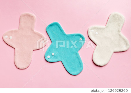 Eco-friendly reusable fabric women's pads. set of colorful bright reusable menstrual pads. zero waste woman periods concept top view with copy space Eco-friendly reusable fabric women's pads. set of colorful bright reusable menstrual pads. zero waste woman periods concept top view with copy space 126929260