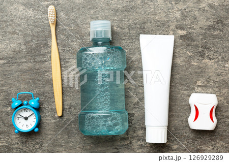 Mouthwash and other oral hygiene products on colored table top view with copy space. Flat lay. Dental hygiene. Oral care products and space for text on light background. concept 126929289