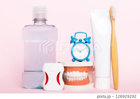 Mouthwash and other oral hygiene products on colored table top view with copy space. Flat lay. Dental hygiene. Oral care kit. Dentist concept Mouthwash and other oral hygiene products on colored table top view with copy space. Flat lay. Dental hygiene. Oral care kit. Dentist concept 126929292