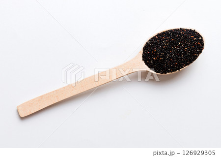 quinoa seeds in spoon on colored background. Healthy kinwa in small spoon. Healthy superfood quinoa seeds in spoon on colored background. Healthy kinwa in small spoon. Healthy superfood 126929305