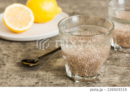 Healthy breakfast or morning with chia seeds and lemon on table background, vegetarian food, diet and health concept. Chia pudding with lemon 126929319