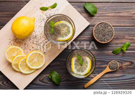 Healthy breakfast or morning with chia seeds lemon and mint on table background, vegetarian food, diet and health concept. Chia pudding with lemon and mint Healthy breakfast or morning with chia seeds lemon and mint on table background, vegetarian food, diet and health concept. Chia pudding with lemon and mint 126929320